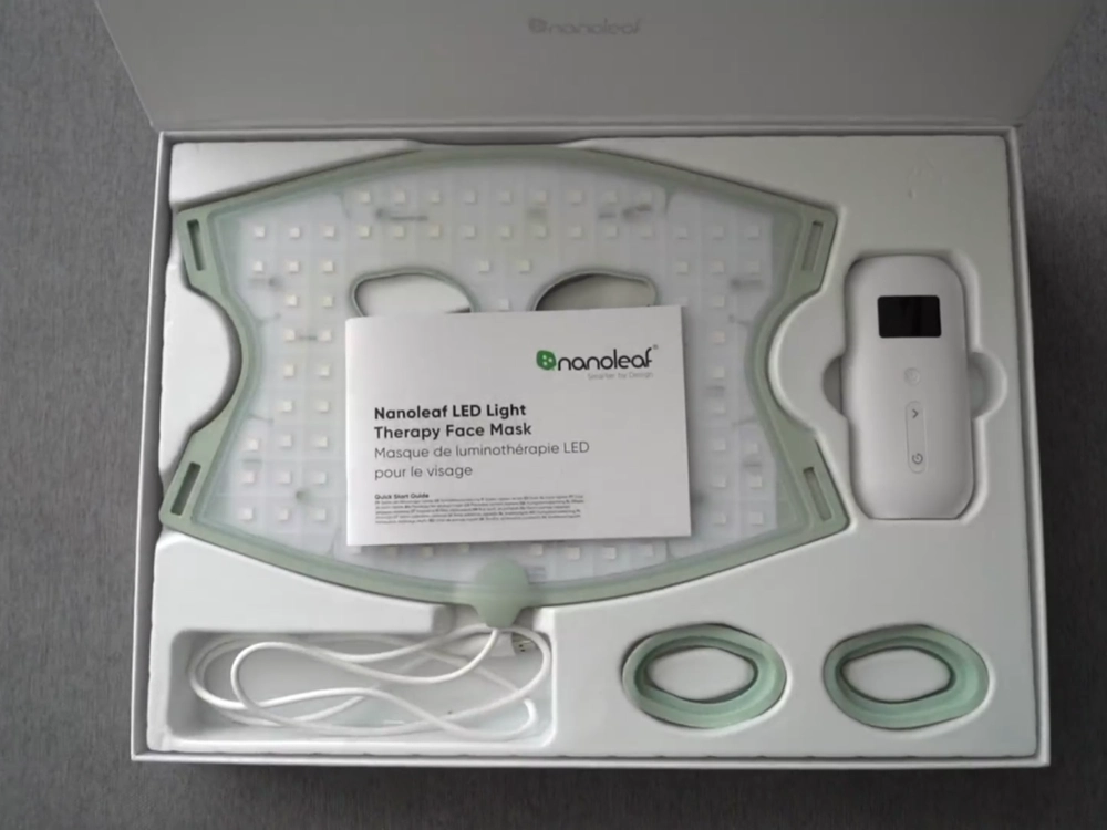 Nanoleaf LED mask box open, showing the mask, controller, USB-C cable, two eye shields and a bilingual English and French quick start guide