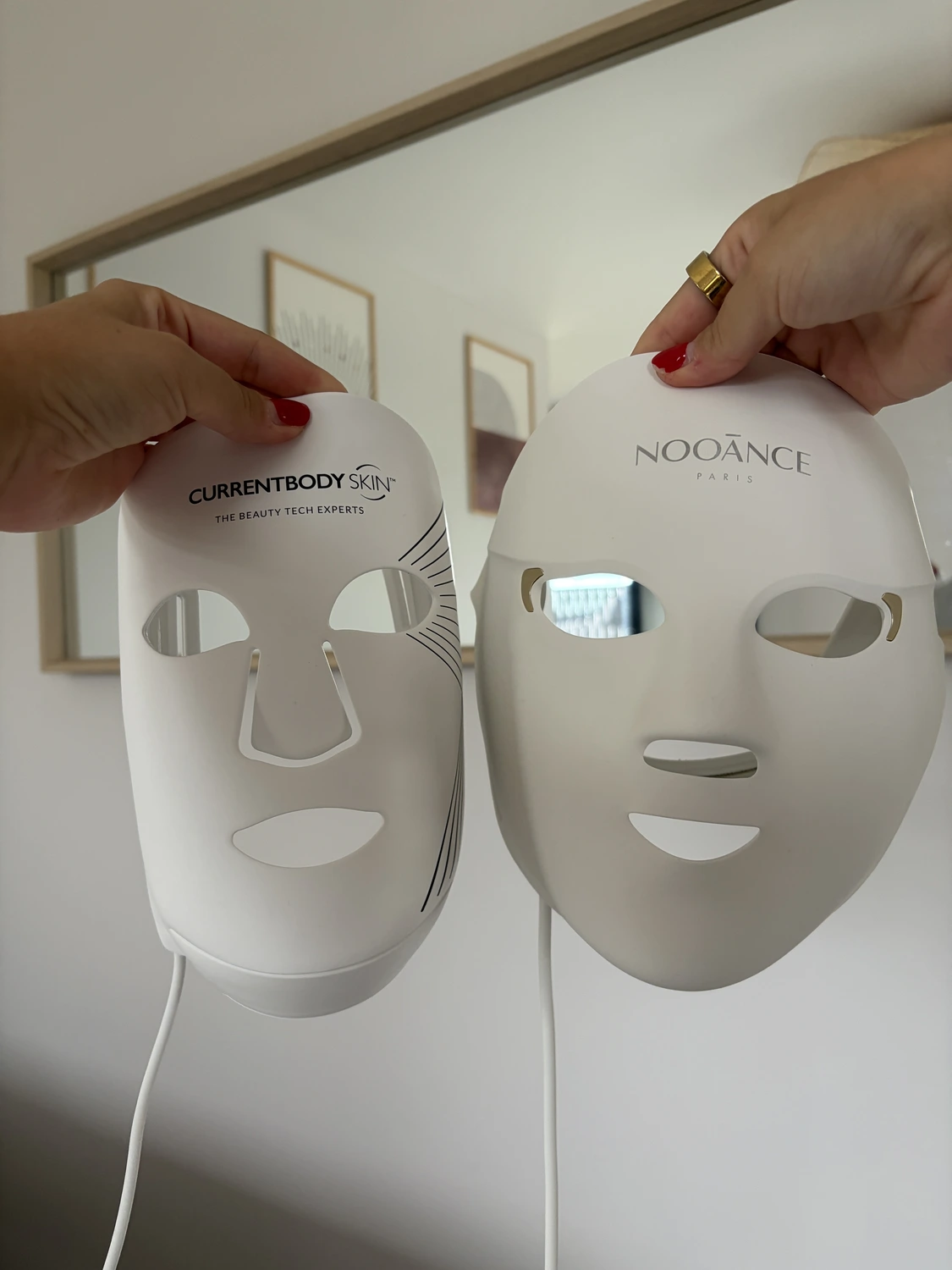 Front view of both LED masks switched off, the CurrentBody Series 2 with nose and eye cutouts and the Nooance Elite X600 with its eye shields fitted